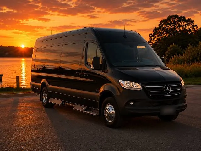 Black Mercedes-Benz Sprinter 15-passenger van at sunset